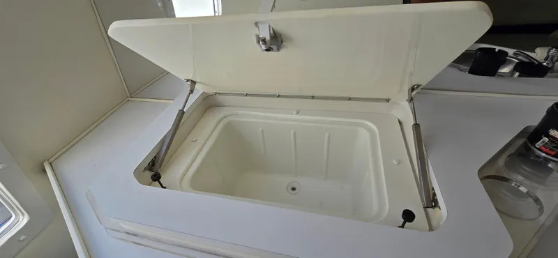 Slide: The Image of Open storage compartment on a 2007 Fountain 42 Executioner boat. - 26