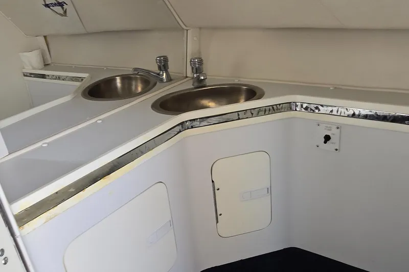 Slide: The Image of Interior of 2007 Fountain 42 Executioner boat with dual sinks and white cabinetry. - 28
