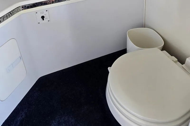 Slide: The Image of 2007 Fountain 42 Executioner boat bathroom with toilet and wastebasket. - 29