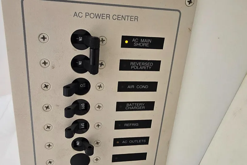 Slide: The Image of 2007 Fountain 42 Executioner AC power center panel with switches and indicators. - 31