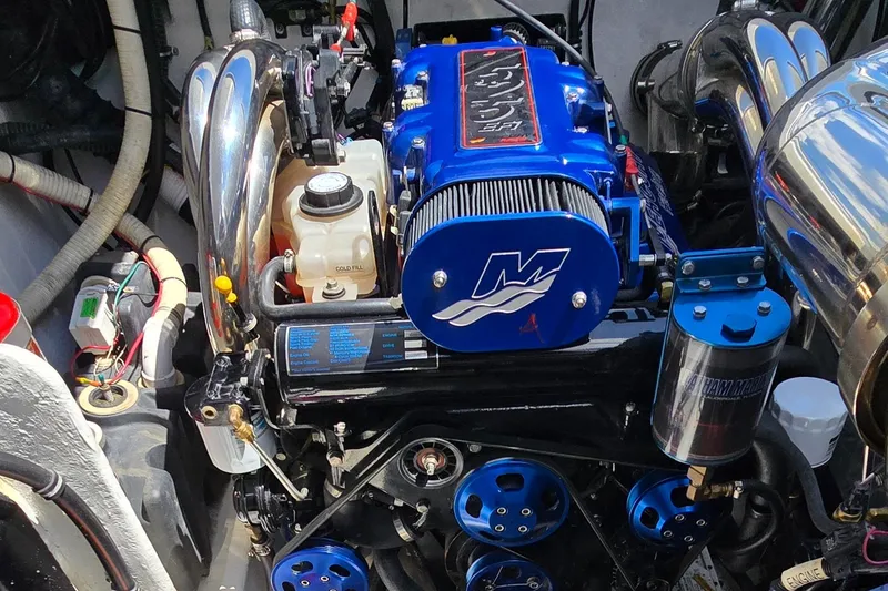 Slide: The Image of Engine of a 2007 Fountain 42 Executioner boat, featuring blue and chrome components. - 34