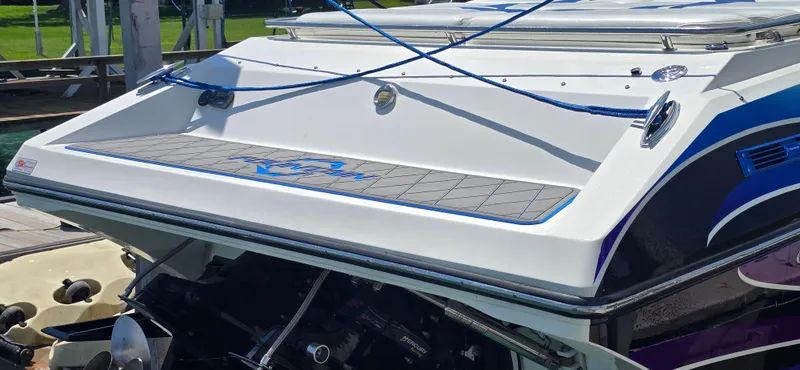 Slide: The Image of 2007 Fountain 42 Executioner boat with sleek design and vibrant blue accents at a dock. - 6