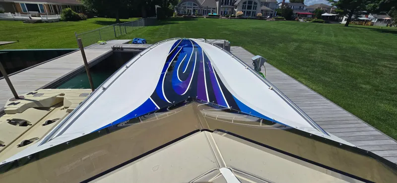 Slide: The Image of 2007 Fountain 42 Executioner speedboat with vibrant blue and purple design docked on a sunny day. - 8