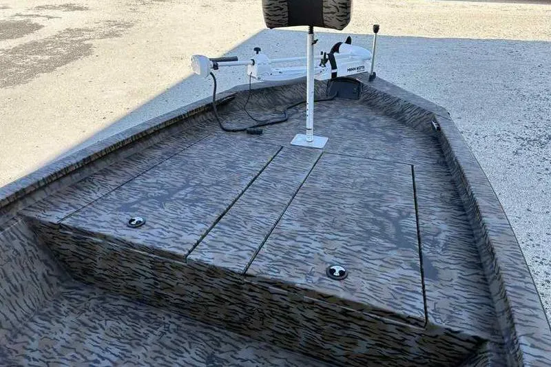 Slide: The Image of 2026 Xpress H210B boat with camo deck and trolling motor. - 13