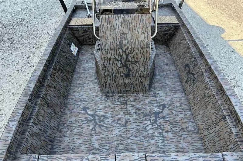 Slide: The Image of 2026 Xpress H210B boat interior with camouflage design and central console. - 15