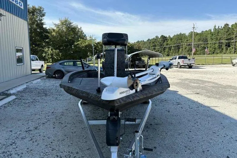 Slide: The Image of 2026 Xpress H210B boat on trailer in outdoor parking lot. - 6