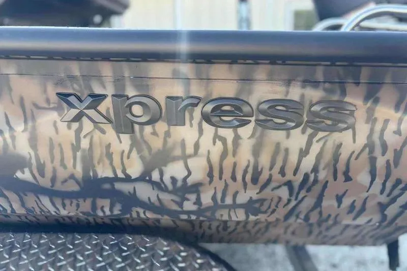 Slide: The Image of Xpress H210B 2026 model with camouflage design and embossed logo. - 8
