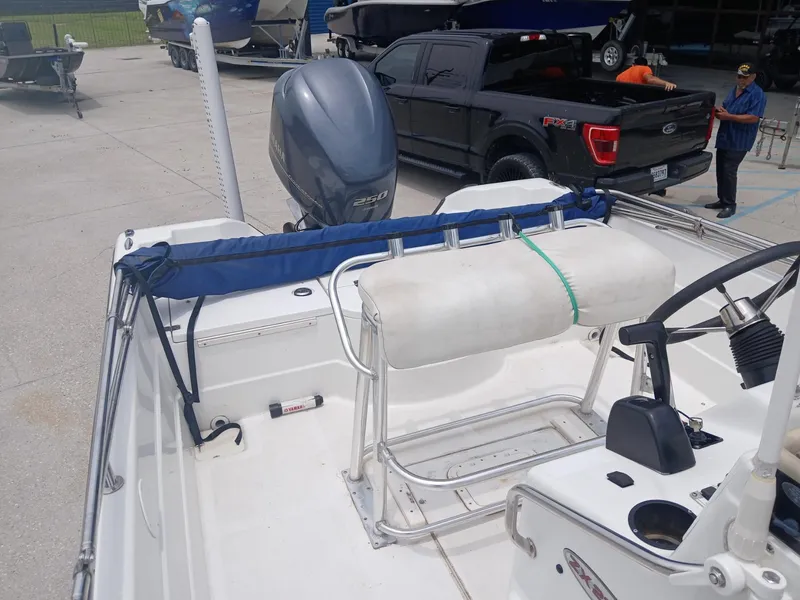 Slide: The Image of 2005 Skeeter ZX 2200 boat with Yamaha 250 engine, parked near a black Ford truck. - 11