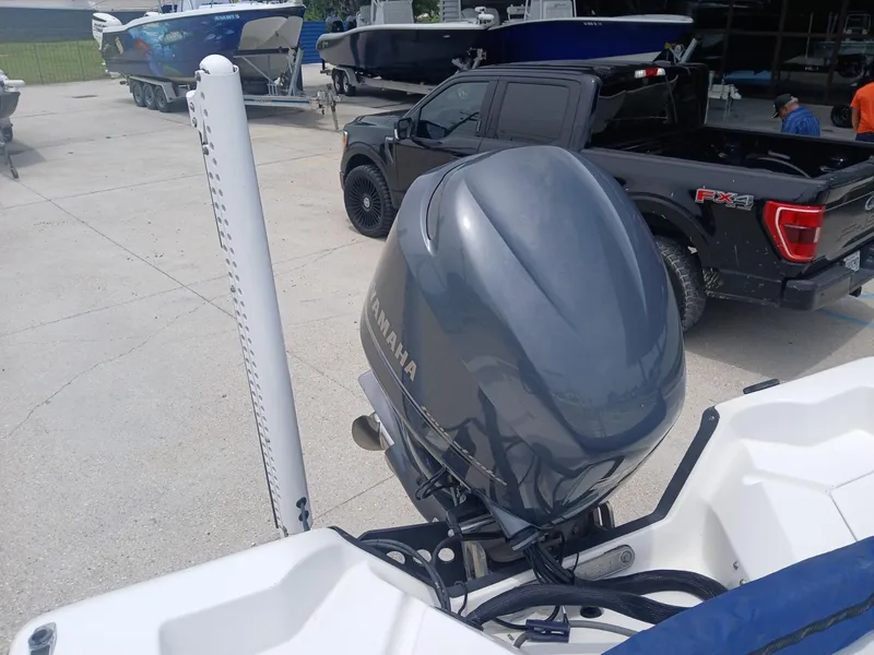 Slide: The Image of 2005 Skeeter ZX 2200 boat with Yamaha outboard motor in a marina setting. - 13