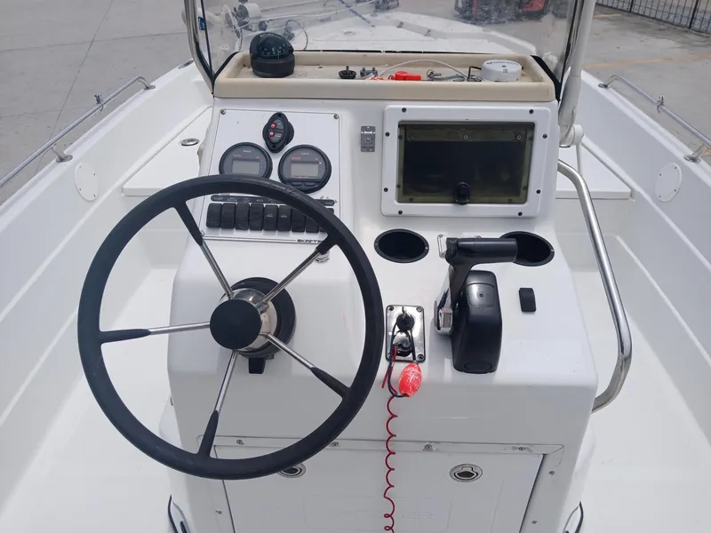 Slide: The Image of 2005 Skeeter ZX 2200 boat console with steering wheel and control panel. - 14