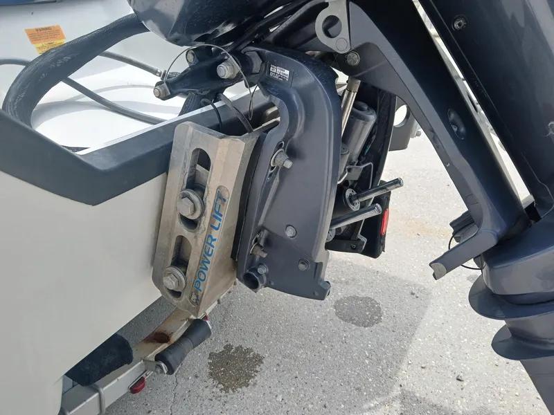 Slide: The Image of 2005 Skeeter ZX 2200 boat motor with Power Lift mechanism on a concrete surface. - 16