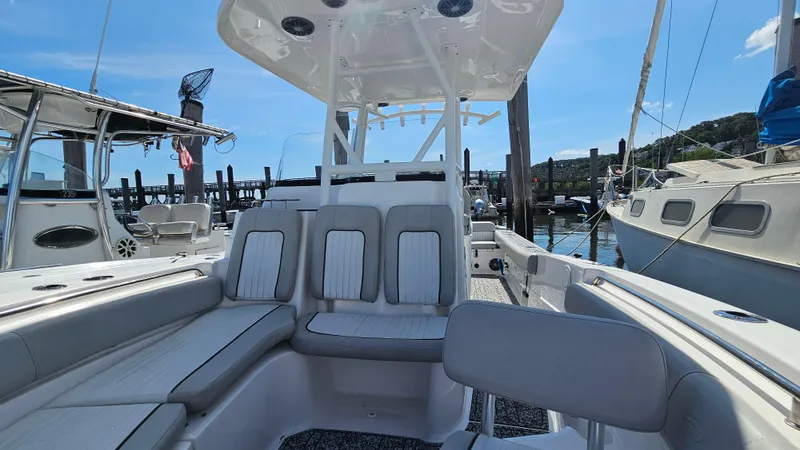Slide: The Image of 2022 Sea Fox 249 Avenger boat interior with seating, docked at marina. - 17