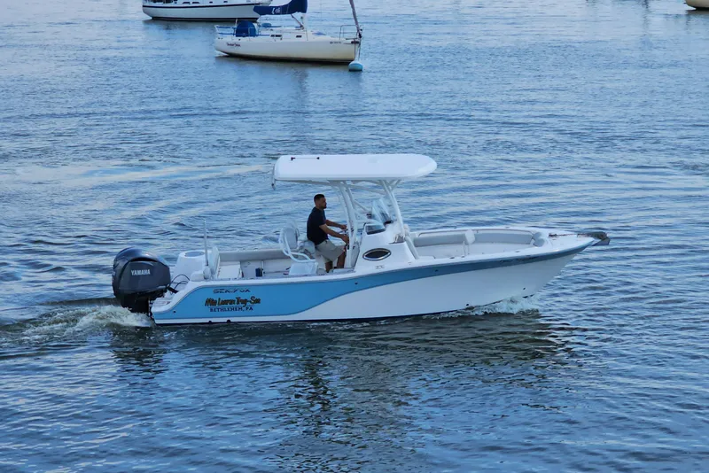 Slide: The Image of 2022 Sea Fox 249 Avenger boat cruising on calm water. - 2