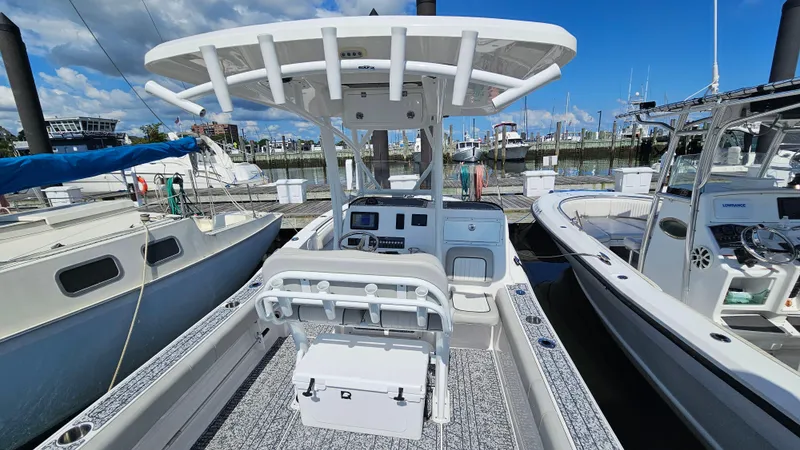 Slide: The Image of 2022 Sea Fox 249 Avenger boat docked at marina under clear blue sky. - 6