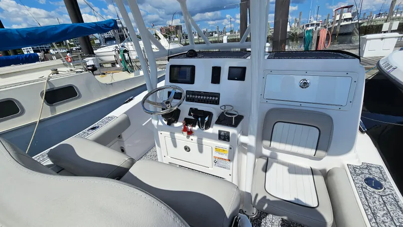 Slide: The Image of 2022 Sea Fox 249 Avenger boat cockpit with steering wheel and control panel. - 9