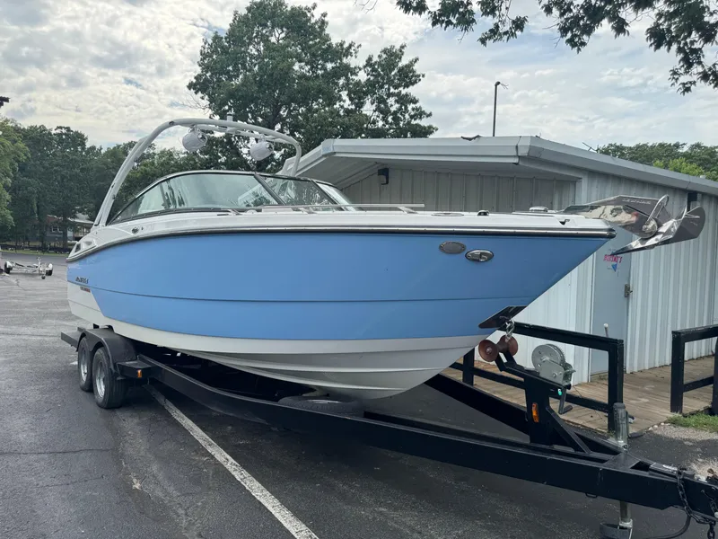 Slide: The Image of 2022 Monterey 278SS Super Sport boat on trailer, parked near a building. - 2