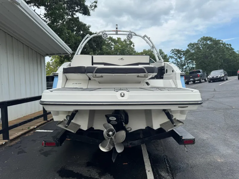 Slide: The Image of 2022 Monterey 278SS Super Sport boat, rear view, parked on a trailer in a lot. - 4