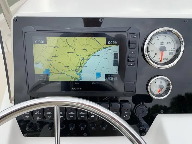 Slide: The Image of 2026 Bulls Bay 2000 boat dashboard with steering wheel and control panel. - 14