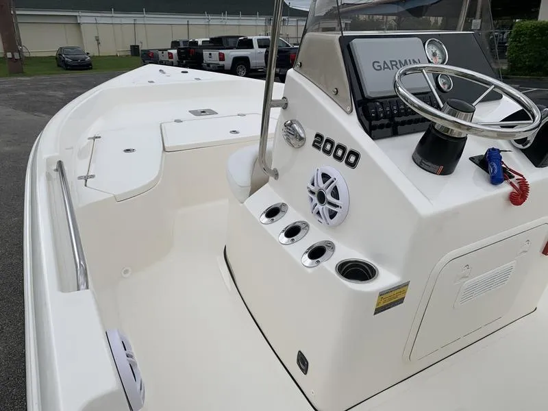 Slide: The Image of 2026 Bulls Bay 2000 boat storage compartment with wiring and battery setup. - 17