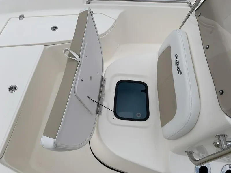 Slide: The Image of 2026 Bulls Bay 2000 boat interior with beige seating and console, featuring cup holders. - 22