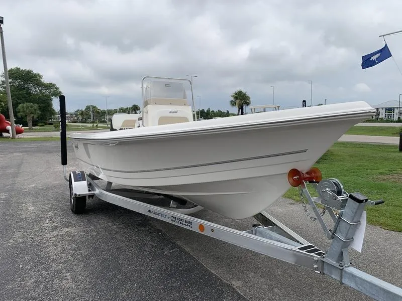 Slide: The Image of 2026 Bulls Bay 2000 boat on trailer, displayed outdoors with flags in background. - 6