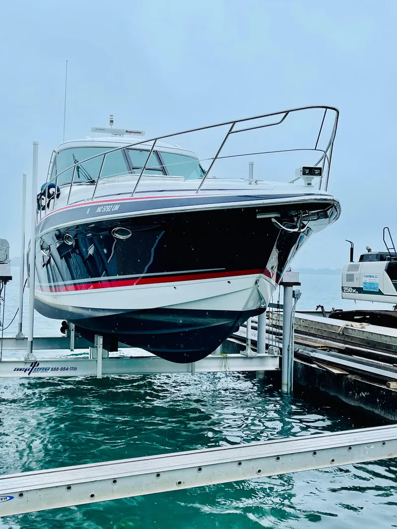Slide: The Image of 2014 Formula 45 Yacht on lift at marina, showcasing sleek design and vibrant colors. - 16