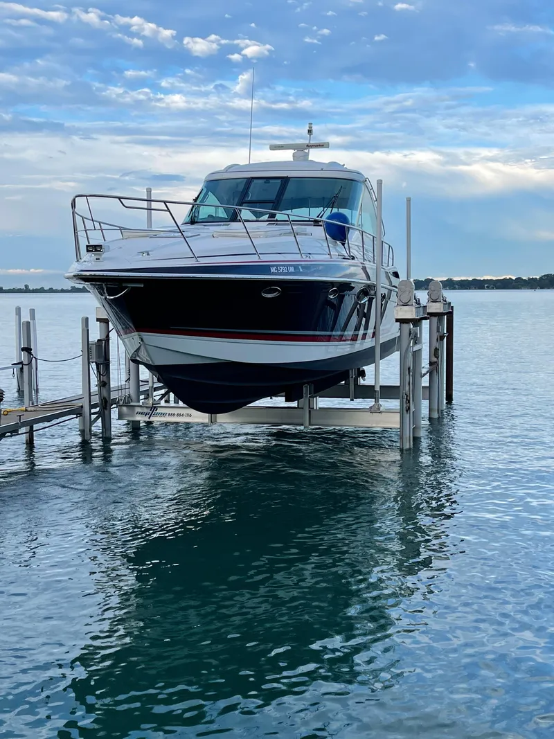 Slide: The Image of 2014 Formula 45 Yacht on lift over calm water, under a partly cloudy sky. - 24