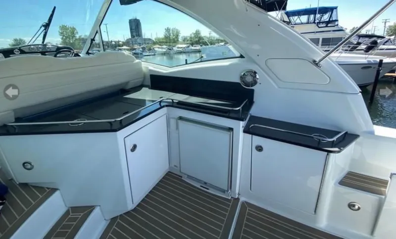 Slide: The Image of 2014 Formula 45 Yacht interior with sleek cabinetry and seating, docked at a marina. - 31