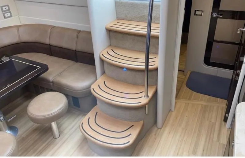 Slide: The Image of Interior of 2014 Formula 45 Yacht with curved seating and wooden stairs. - 43