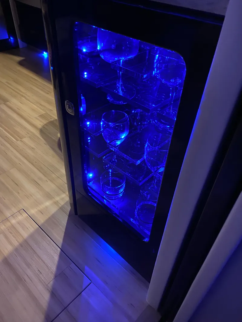 Slide: The Image of Illuminated glass cabinet with blue LED lights on a 2014 Formula 45 Yacht. - 45