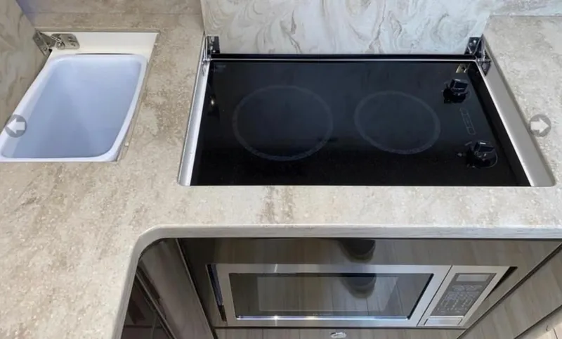 Slide: The Image of Modern kitchen area in a 2014 Formula 45 Yacht with stove and microwave. - 47