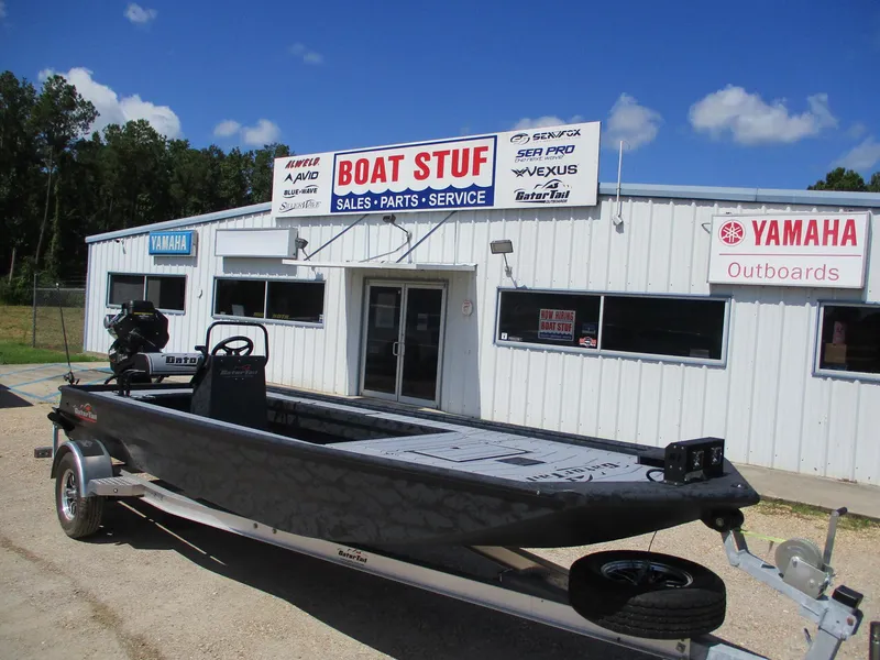Slide: The Image of 2025 Gator Tail 2060 EXTREME boat outside "Boat Stuff" store with Yamaha signage. - 1