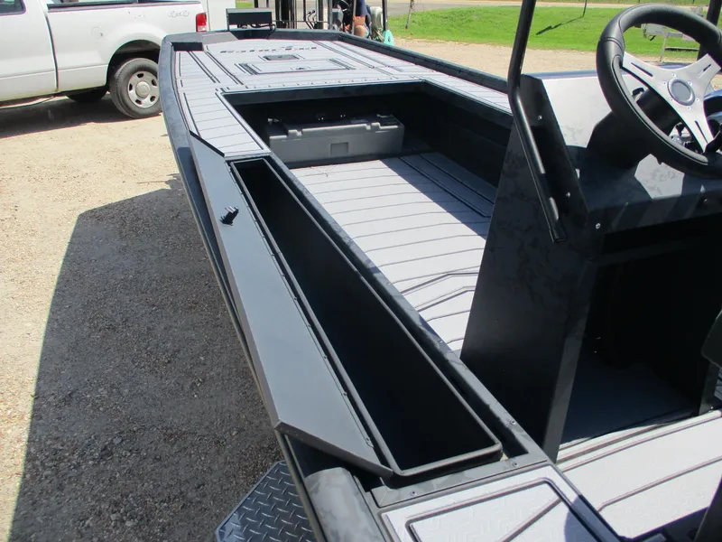 Slide: The Image of 2025 Gator Tail 2060 EXTREME boat interior with storage compartments and steering console. - 13