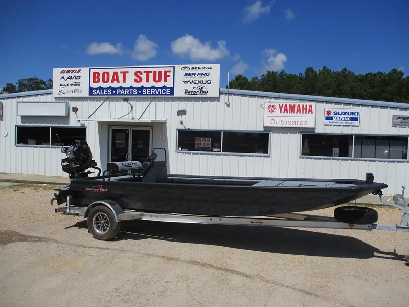 Slide: The Image of 2025 Gator Tail 2060 EXTREME boat on trailer outside dealership, clear sky background. - 2