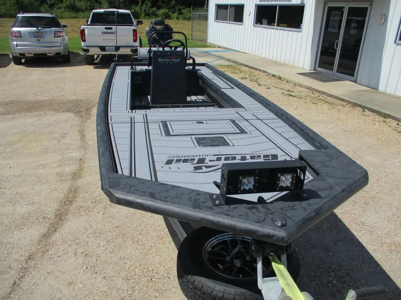 Slide: The Image of 2025 Gator Tail 2060 EXTREME boat on trailer, parked outside a building. - 6