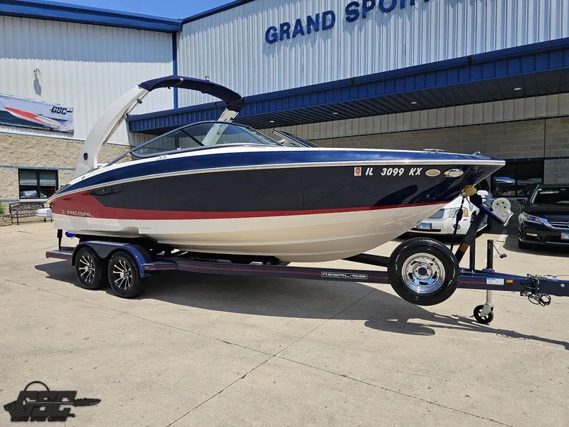 Slide: The Image of 2018 Regal 2300 Bowrider boat on trailer outside Grand Sport Center. - 11