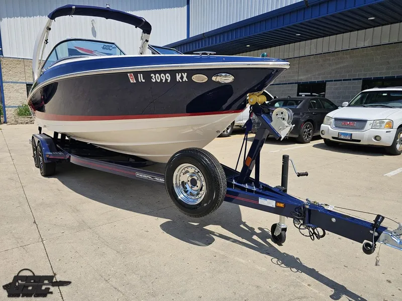 Slide: The Image of 2018 Regal 2300 Bowrider boat on trailer in parking lot. - 12