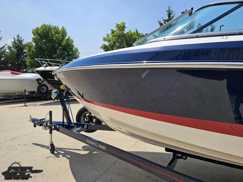Slide: The Image of 2018 Regal 2300 Bowrider boat on trailer, parked outdoors. - 21