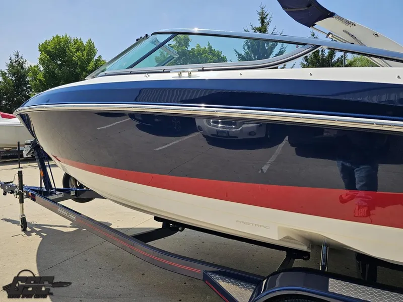 Slide: The Image of 2018 Regal 2300 Bowrider boat on trailer, blue and red exterior. - 25