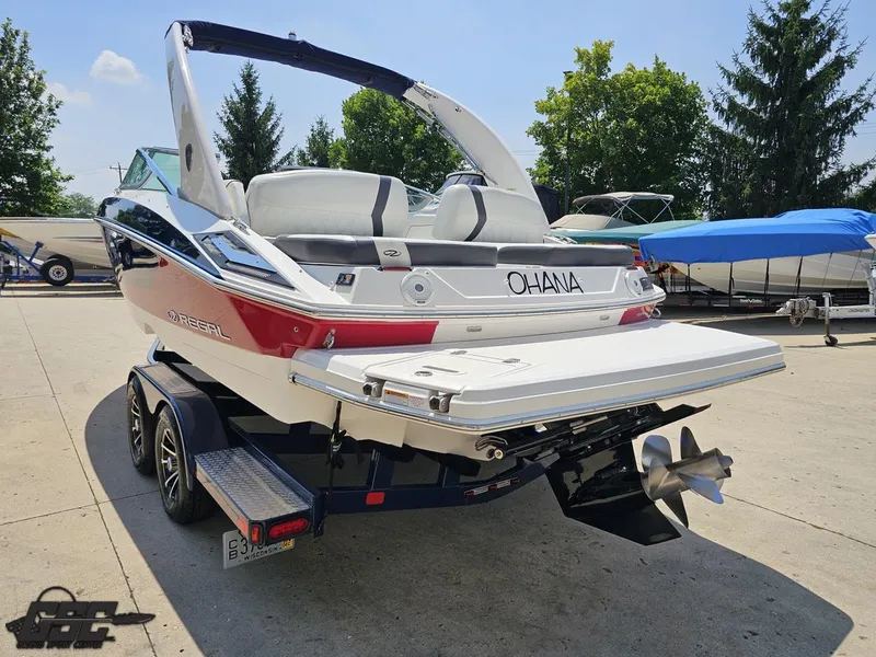 Slide: The Image of 2018 Regal 2300 Bowrider boat on trailer, rear view, sunny day, outdoor setting. - 28