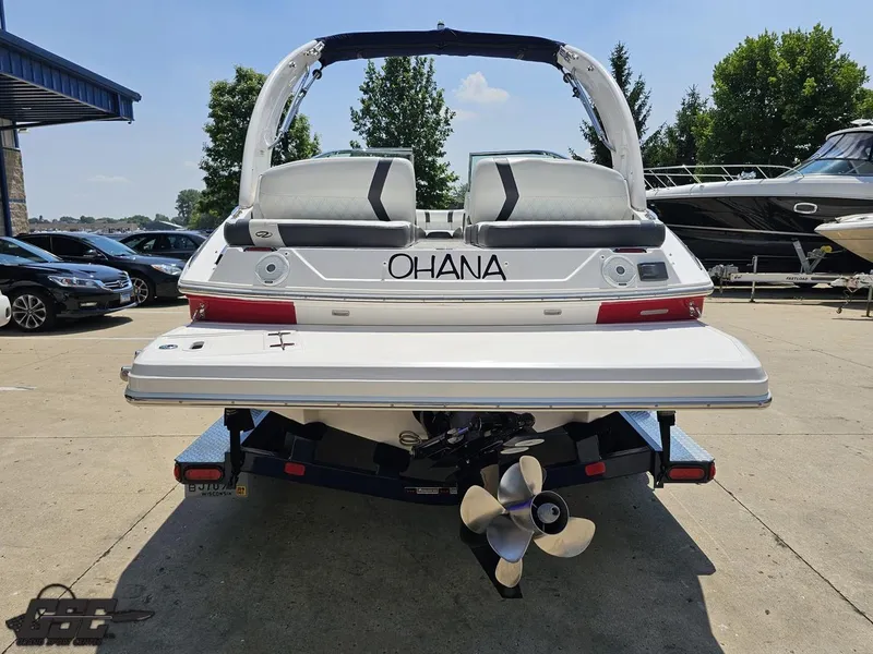 Slide: The Image of 2018 Regal 2300 Bowrider boat on trailer, rear view, sunny day, outdoor setting. - 29