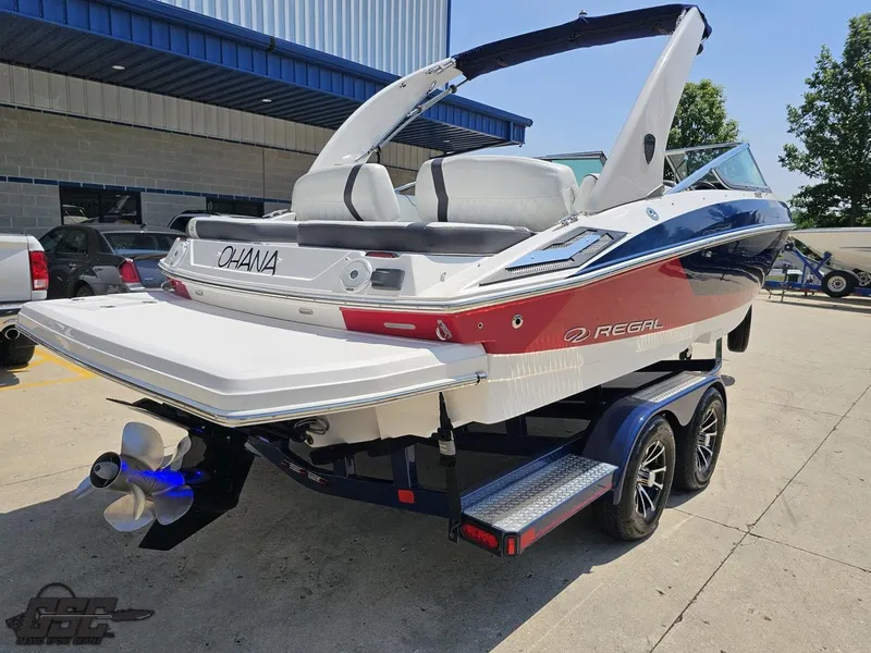 Slide: The Image of 2018 Regal 2300 Bowrider boat on trailer, rear view, parked outdoors. - 32