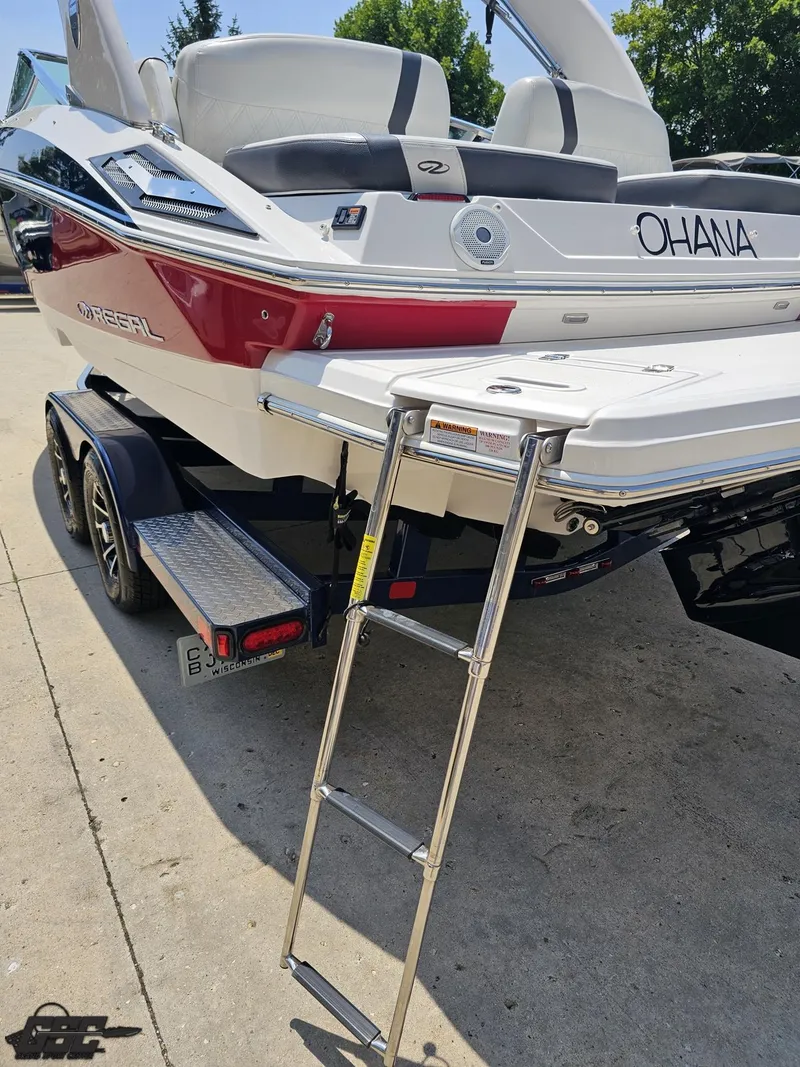 Slide: The Image of 2018 Regal 2300 Bowrider boat with ladder, on trailer, sunny day. - 33
