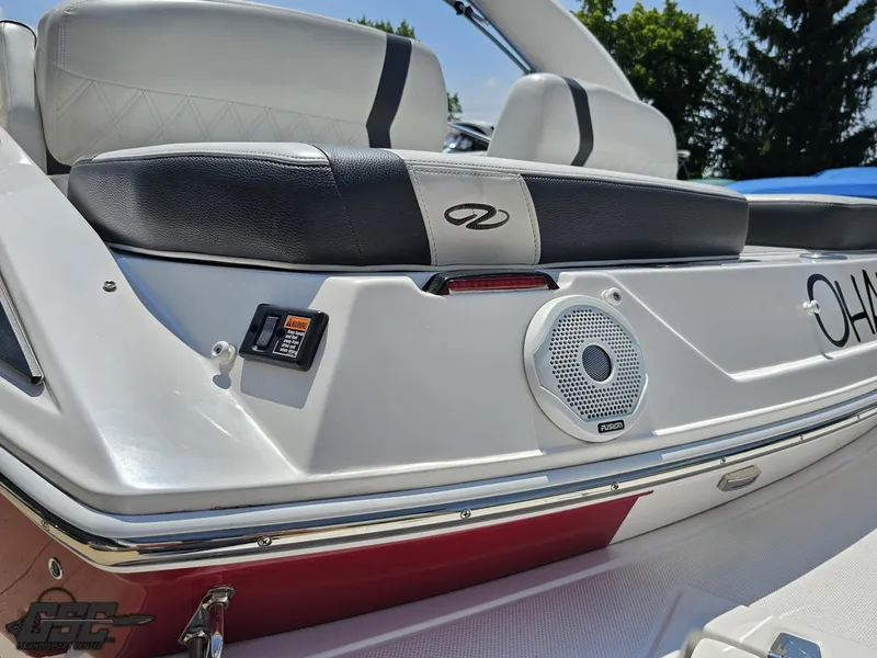 Slide: The Image of 2018 Regal 2300 Bowrider boat with cushioned seating and speaker system, outdoor setting. - 36