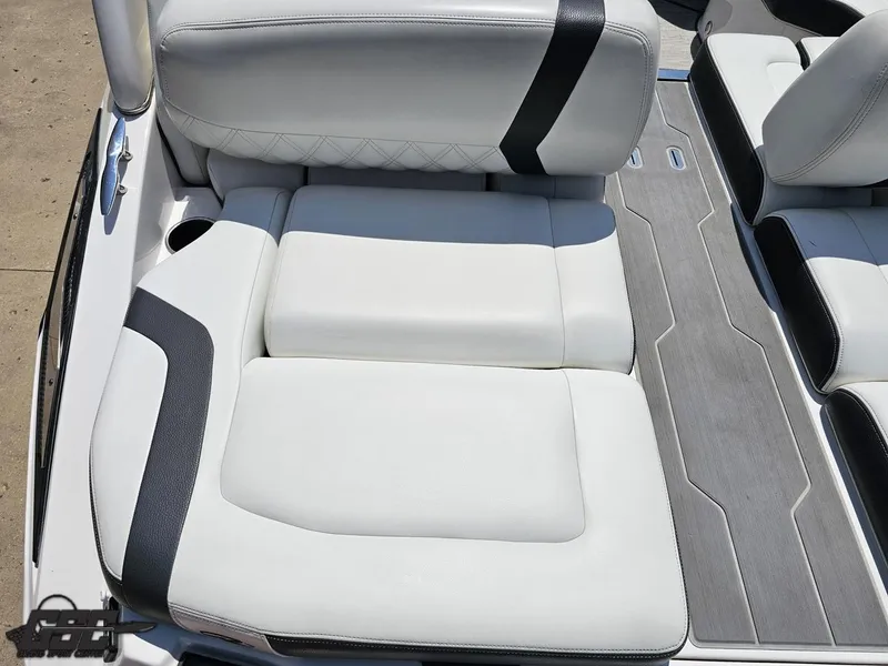 Slide: The Image of 2018 Regal 2300 Bowrider interior seating with white and black upholstery, gray flooring. - 43