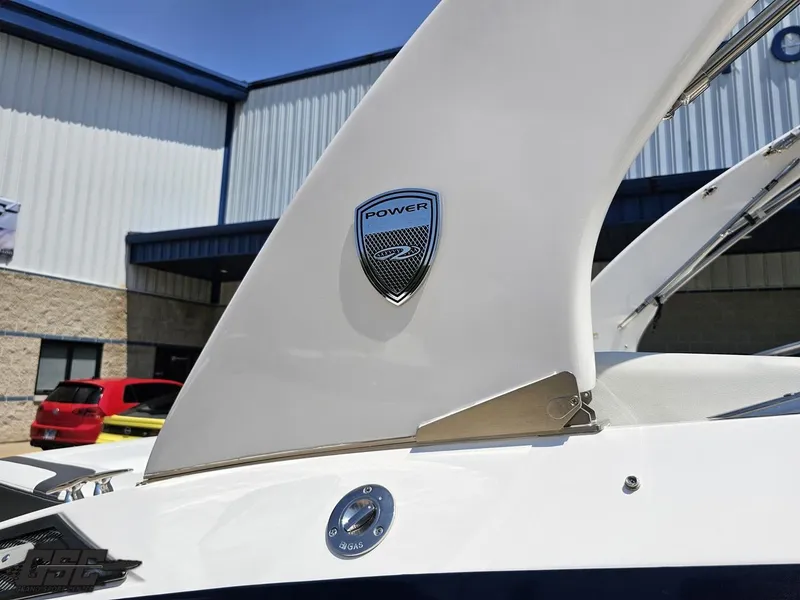 Slide: The Image of 2018 Regal 2300 Bowrider boat detail with Power emblem, outdoor setting. - 6