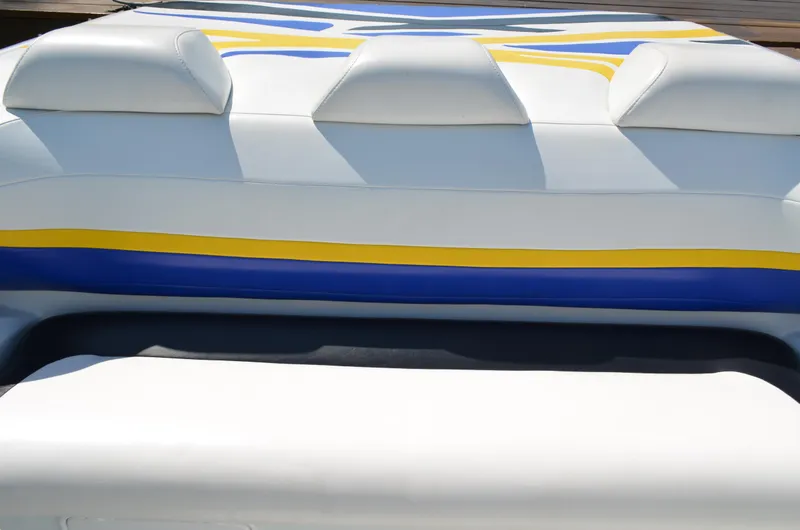 Slide: The Image of 2008 Baja 26 Outlaw boat with white, blue, and yellow upholstery design. - 26