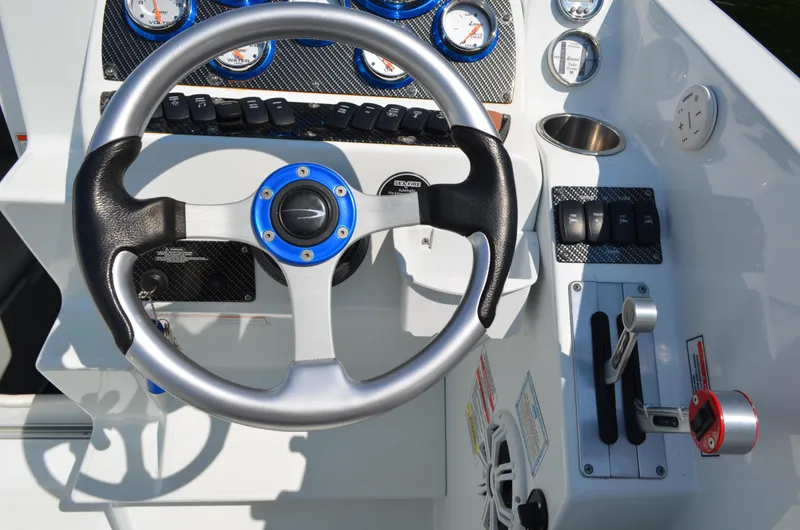 Slide: The Image of 2008 Baja 26 Outlaw boat dashboard with steering wheel and control panel. - 18