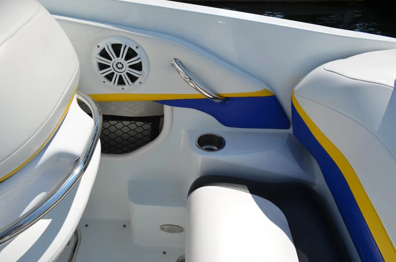 Slide: The Image of Interior of 2008 Baja 26 Outlaw boat with blue and yellow accents, speaker, and seating. - 20