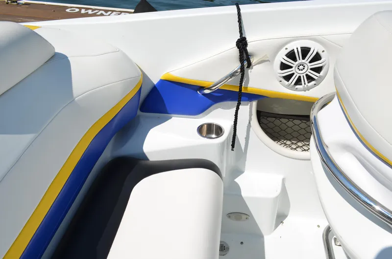 Slide: The Image of 2008 Baja 26 Outlaw boat interior with blue and yellow accents, speaker, and cup holder. - 21